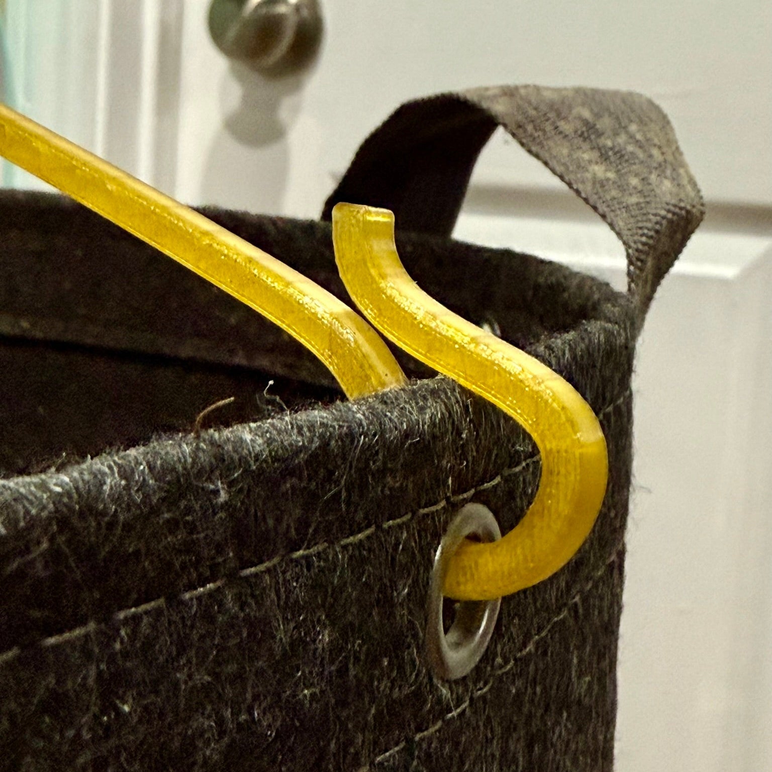 Closeup of HempHook Anchor Hook engaging a pot grommet